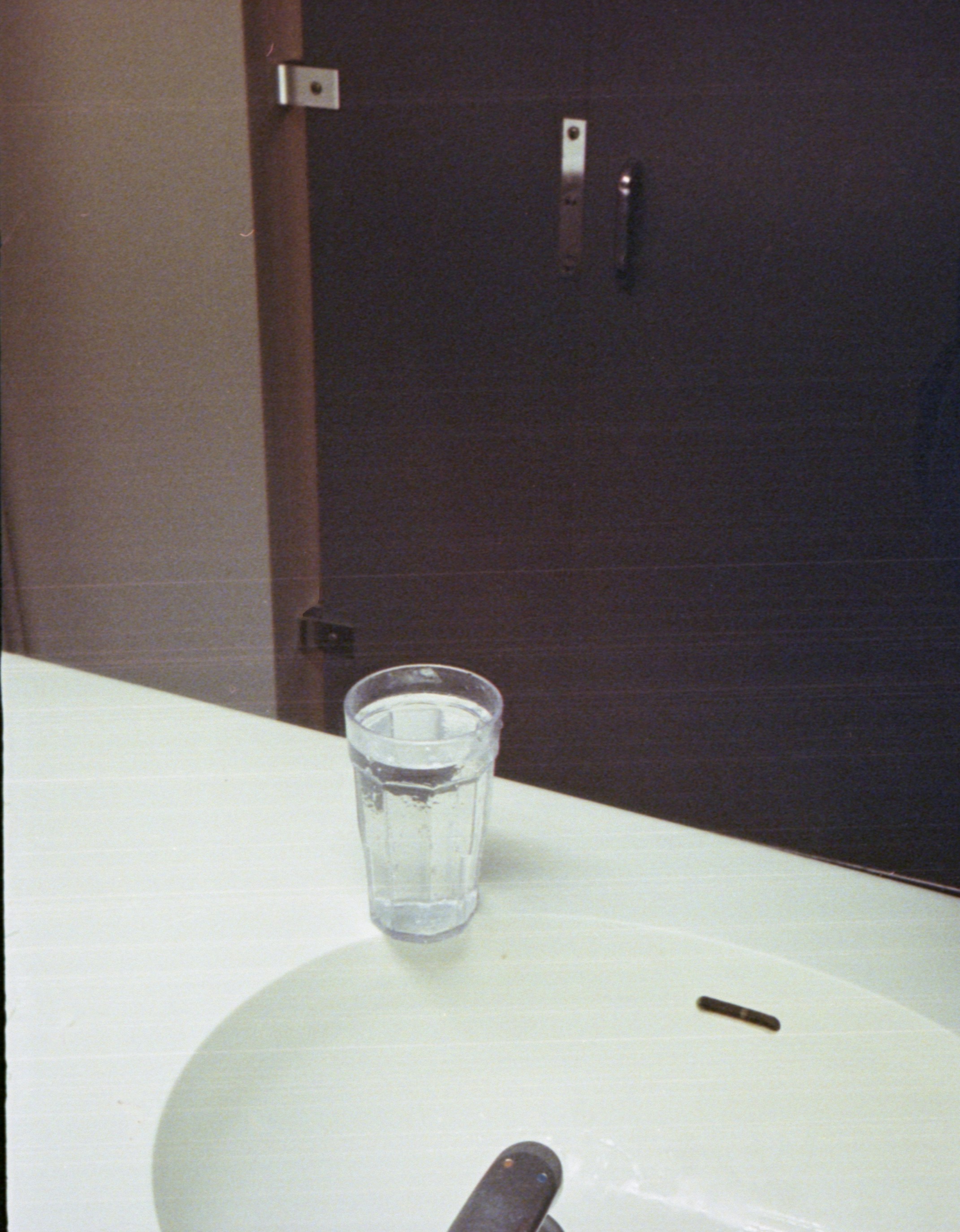 Glass of water on bathroom counter